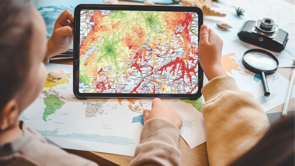 Children watch a digital map on a tablet